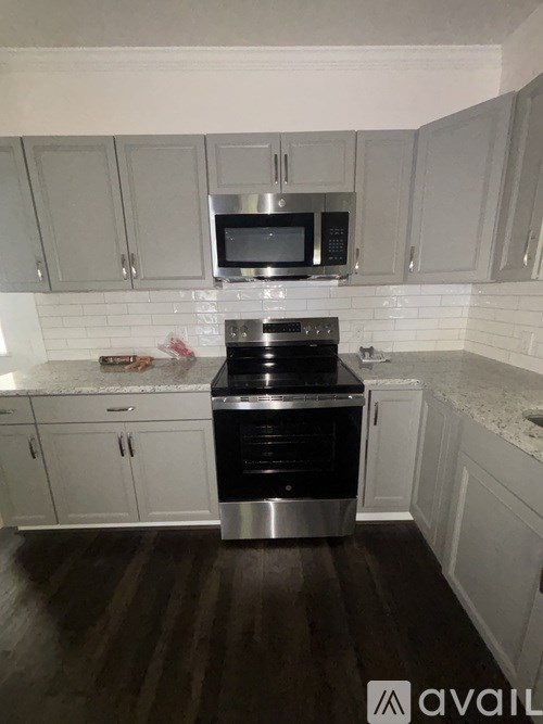 A kitchen with a stove top oven and microwave above it.