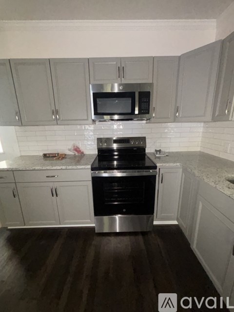 A kitchen with a stove top oven and microwave above it.