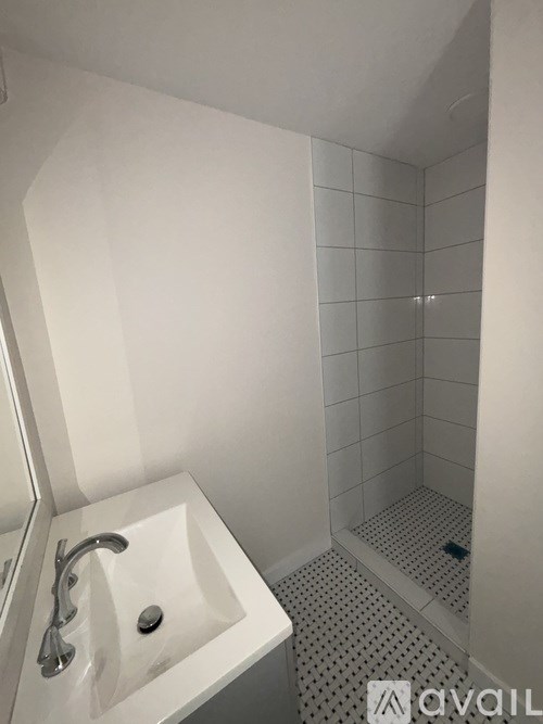 A white sink in a small bathroom.