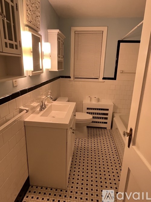 A bathroom with a white sink and toilet.