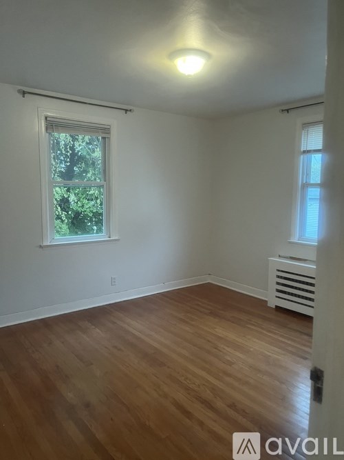 A room with wooden floors and a window.