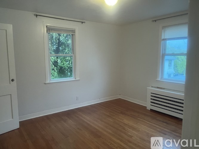 A room with a window and a radiator on the wall.