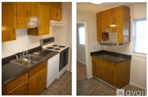 A kitchen with wooden cabinets and a black countertop.