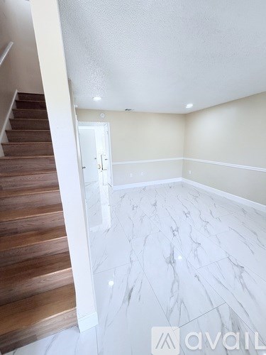 A room with a staircase leading to the upper floor.