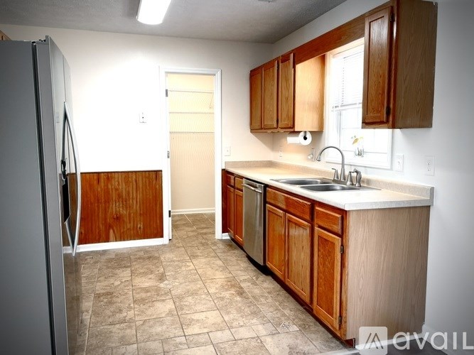 A kitchen with wooden cabinets and a white countertop.