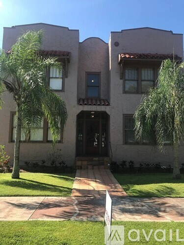 A house with a white sign in front of it.