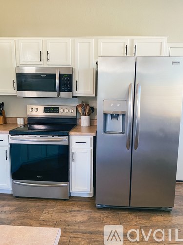 A kitchen with a stainless steel refrigerator and oven.