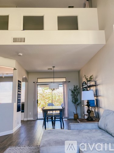 A living room with a couch, a table, and a lamp.