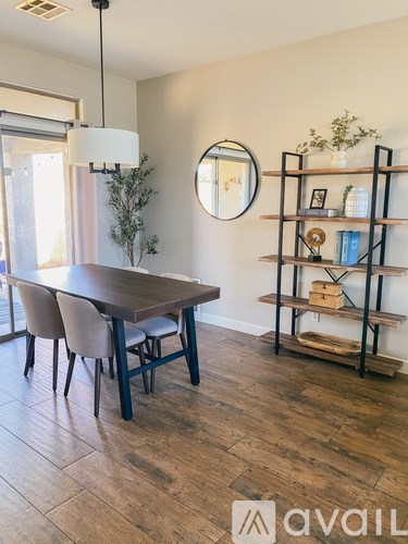 A dining room with a wooden table and chairs.