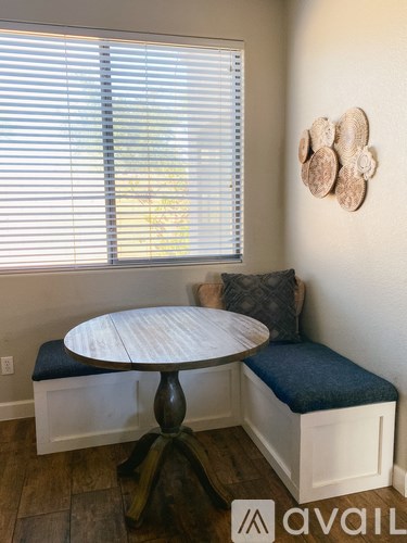 A round table with a bench underneath it.