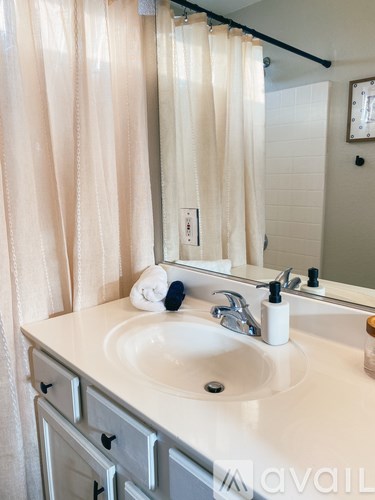 A white sink with a towel on it.