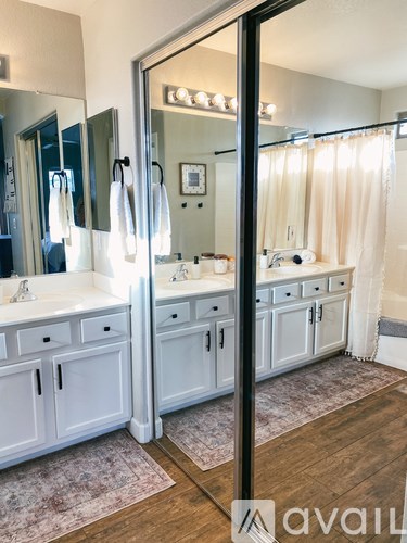 A bathroom with a mirror and a sink.