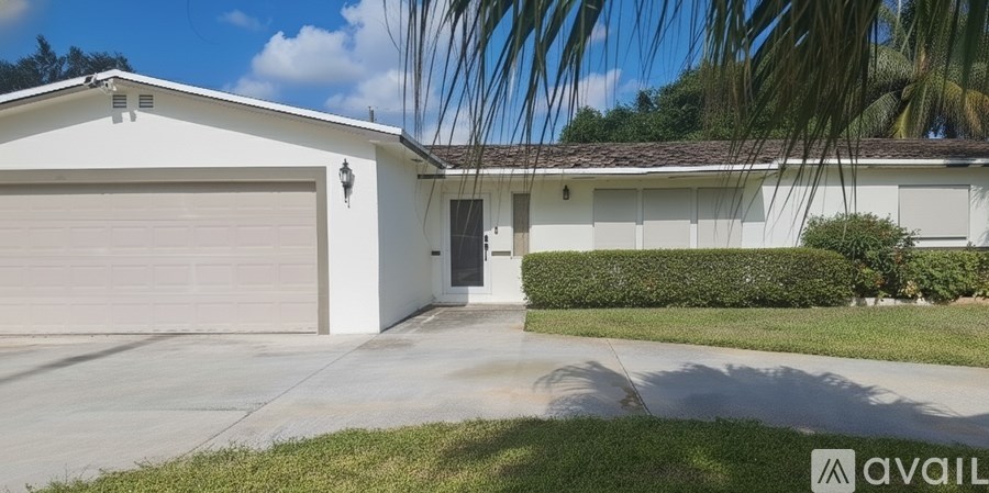 A white house with a garage door and a sign that says "available".