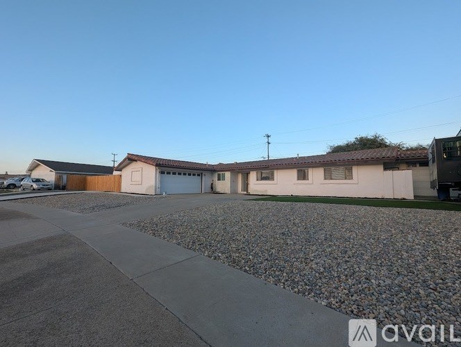 A house with a driveway and a car parked in front.