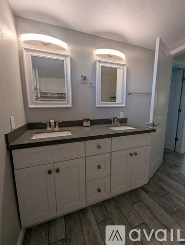 A bathroom with two sinks and two mirrors.
