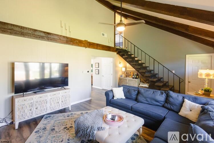 A living room with a blue couch and a television.