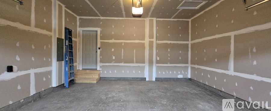 A room under construction with a door and a ladder.