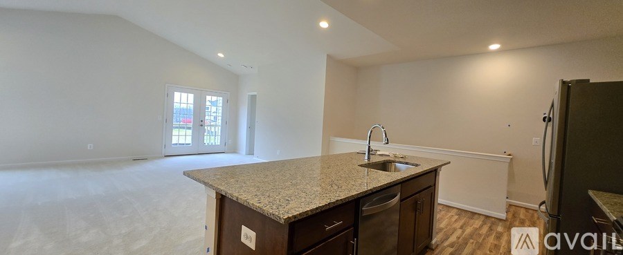 A kitchen with a granite countertop and a sink.