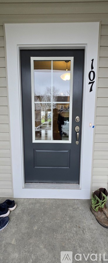 A grey door with the number 107 on it.