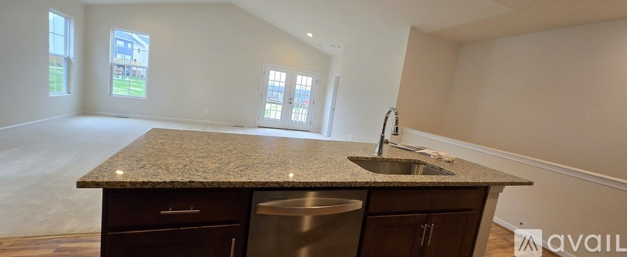 A kitchen with granite countertops and a sink.