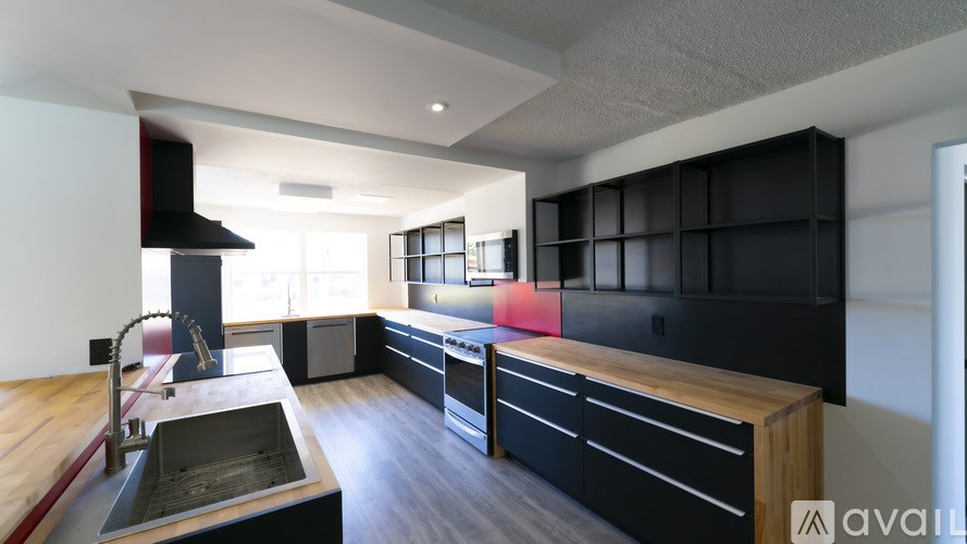 A modern kitchen with a black and wood theme.
