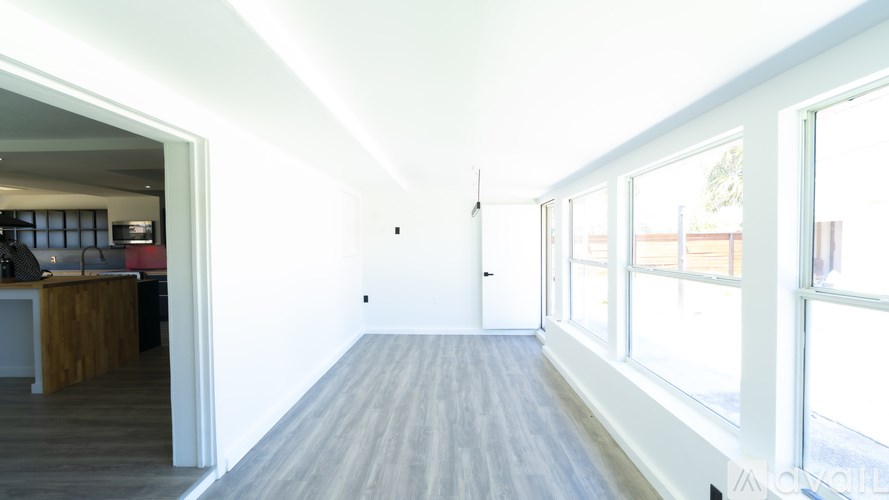 A long, empty hallway with a door at the end.