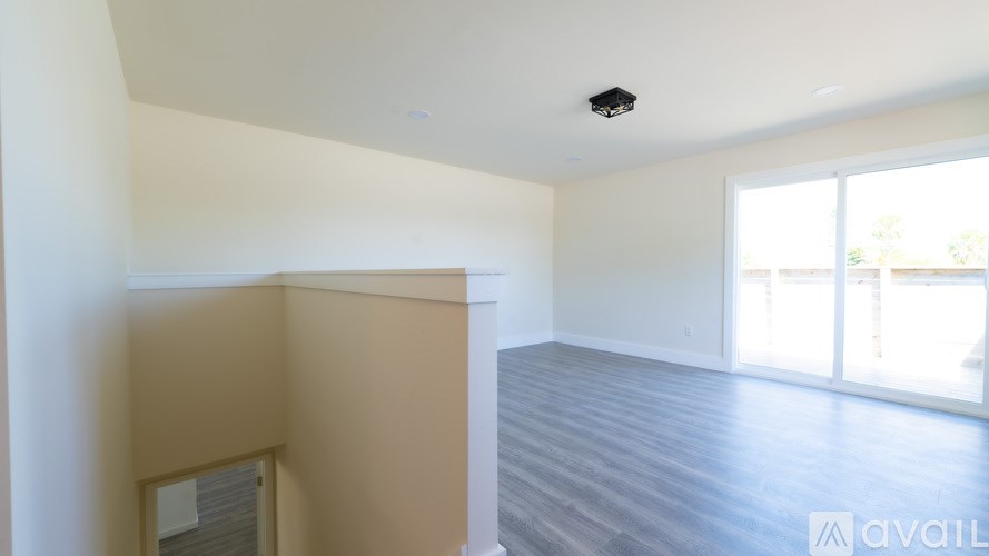 A room with a wooden floor and a large window.