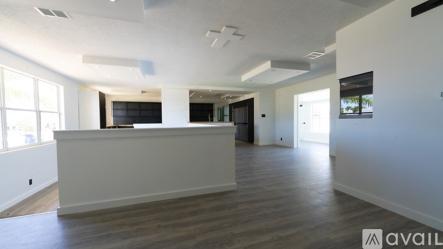 A spacious office with a reception desk and large windows.