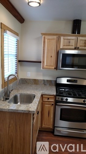 A kitchen with wooden cabinets and stainless steel appliances.