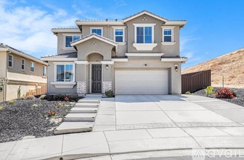 A modern two-story house with a garage and a driveway.