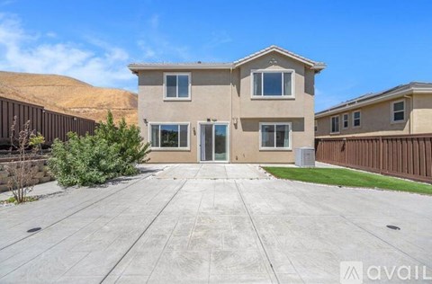 A house with a large front yard is for sale.