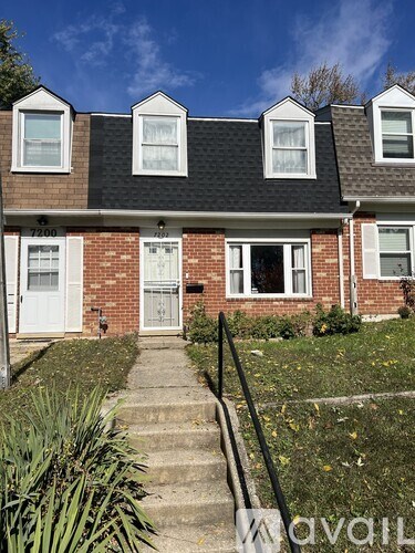 A house with a brick facade and a white door.