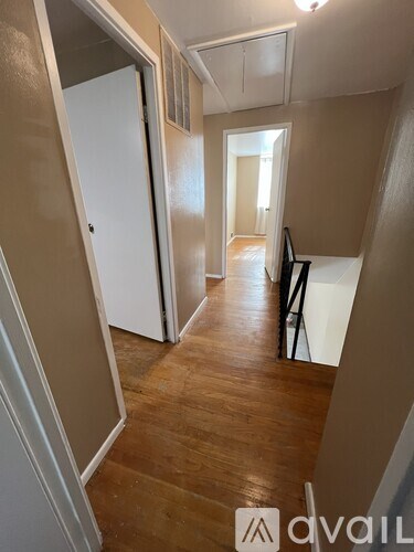 A hallway with a white door and a white cabinet.