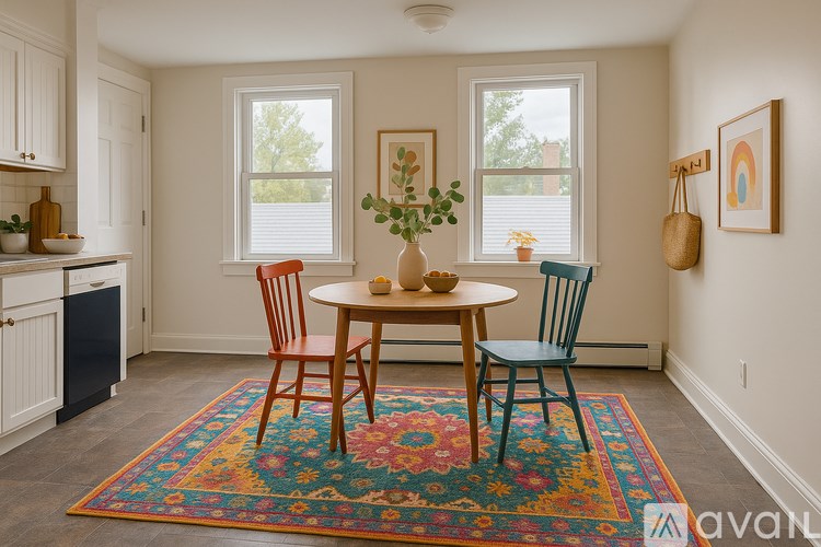 A dining room with a table and chairs.