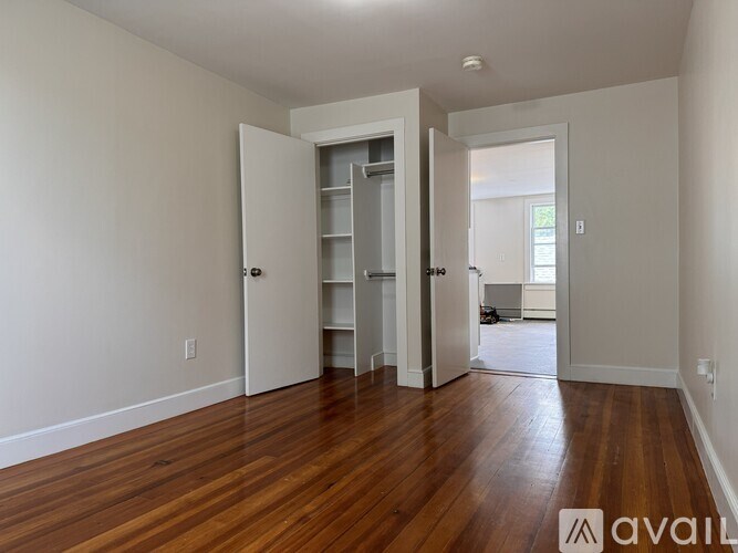 A room with wooden floors and a white door.