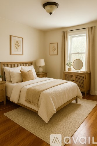 A bedroom with a large bed and a window with curtains.