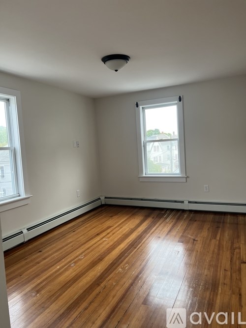 A room with wooden floors and a window.