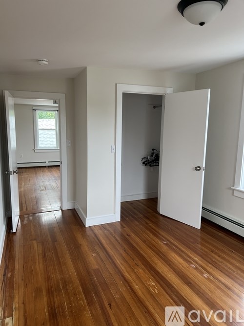 A room with wooden floors and white walls.