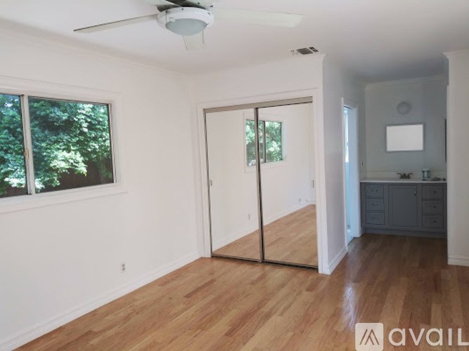 A room with a sliding door and a ceiling fan.