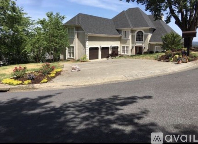 A large house with a driveway in front of it.