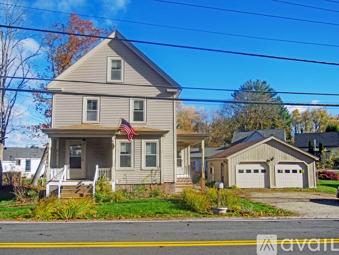 A house with a grey facade and a red flag on the front.