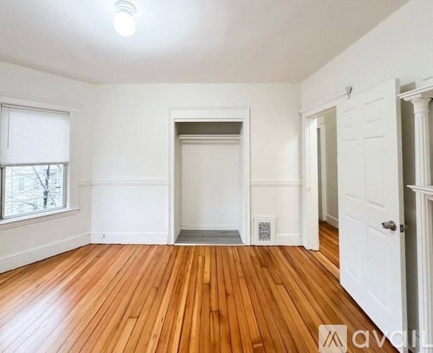 A room with wooden floors and white walls.