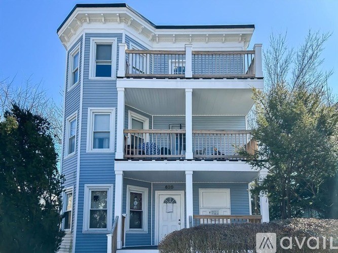 A two-story house with a balcony on the second floor.