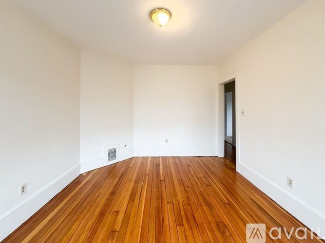 A room with wooden floors and white walls.