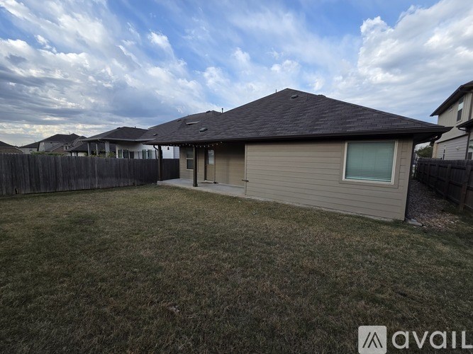 A house with a fence and a grassy yard is available for sale.