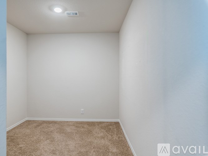 A room with a carpeted floor and white walls.