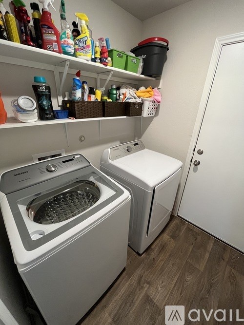 A small laundry room with a washer and dryer.