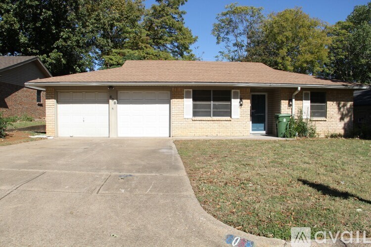 A house with a brown roof and a white garage door.