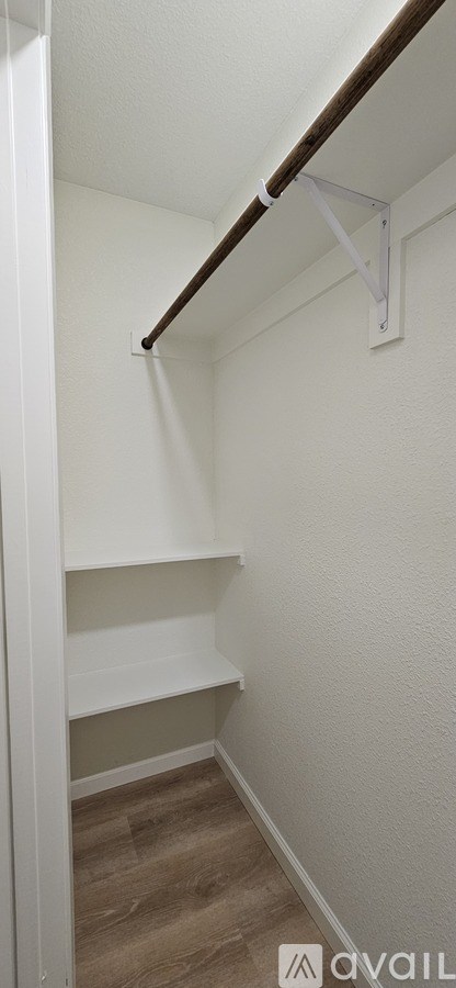 A white wall with a brown strip at the top.