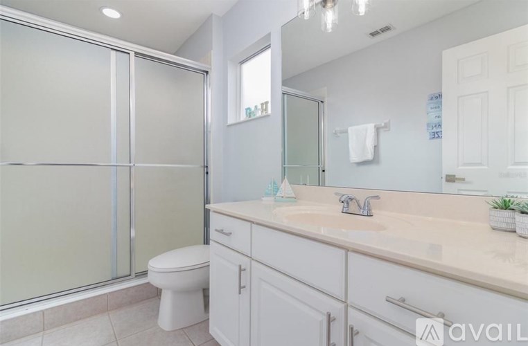 A bathroom with a toilet, sink, and shower.